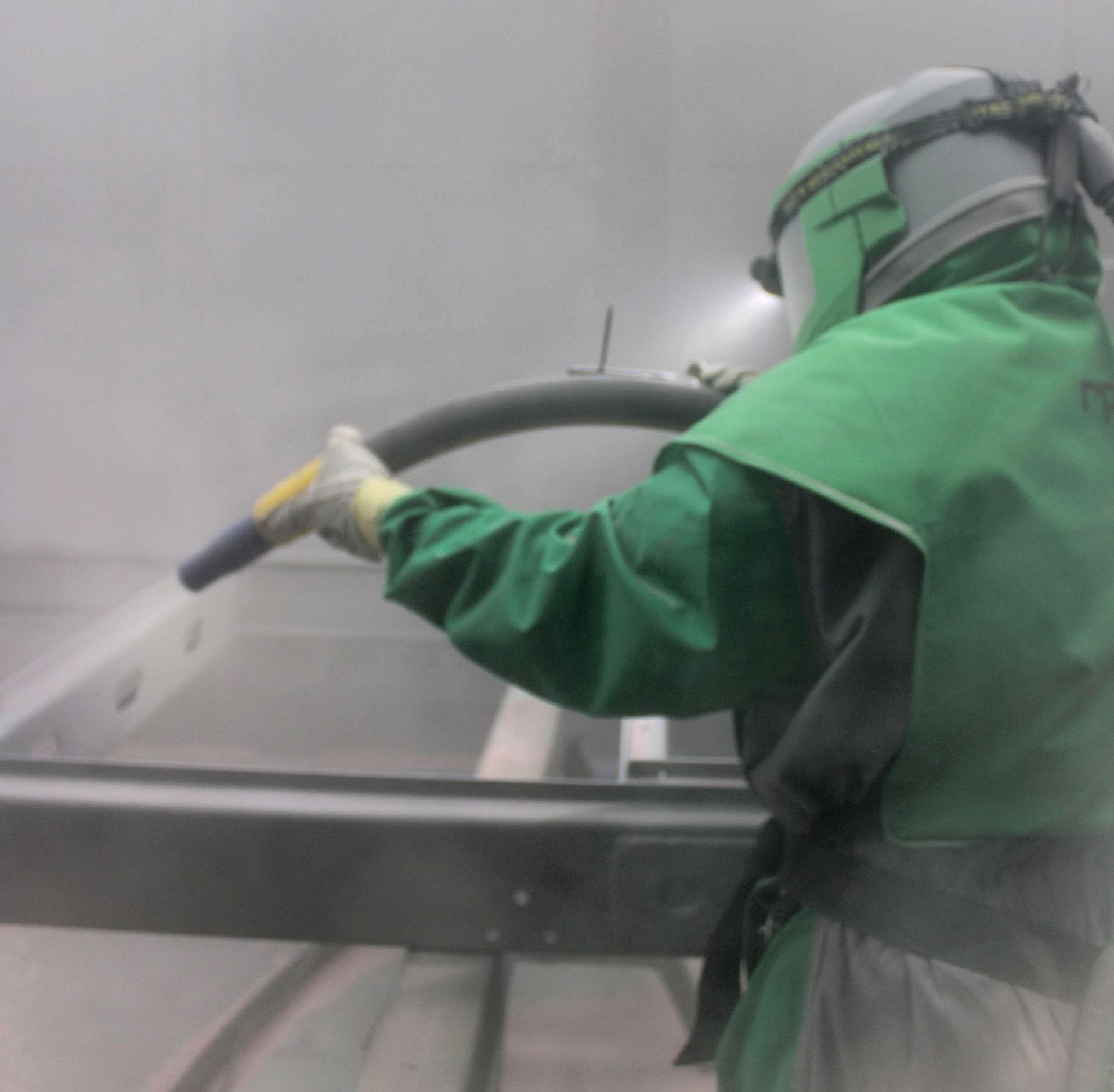 Professional Coating staff sandblast trailer chassis, removing any imperfections.