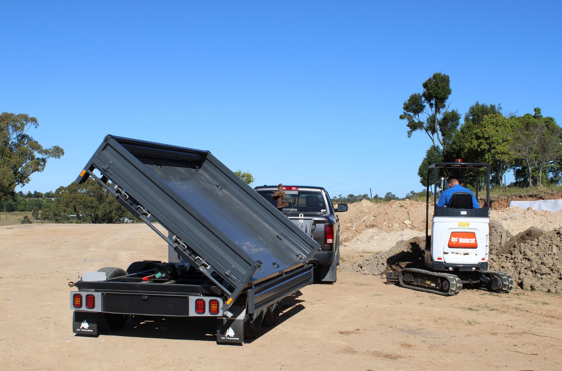 Rear view of Michael Brutons three-way tipping trailer in mid tip.