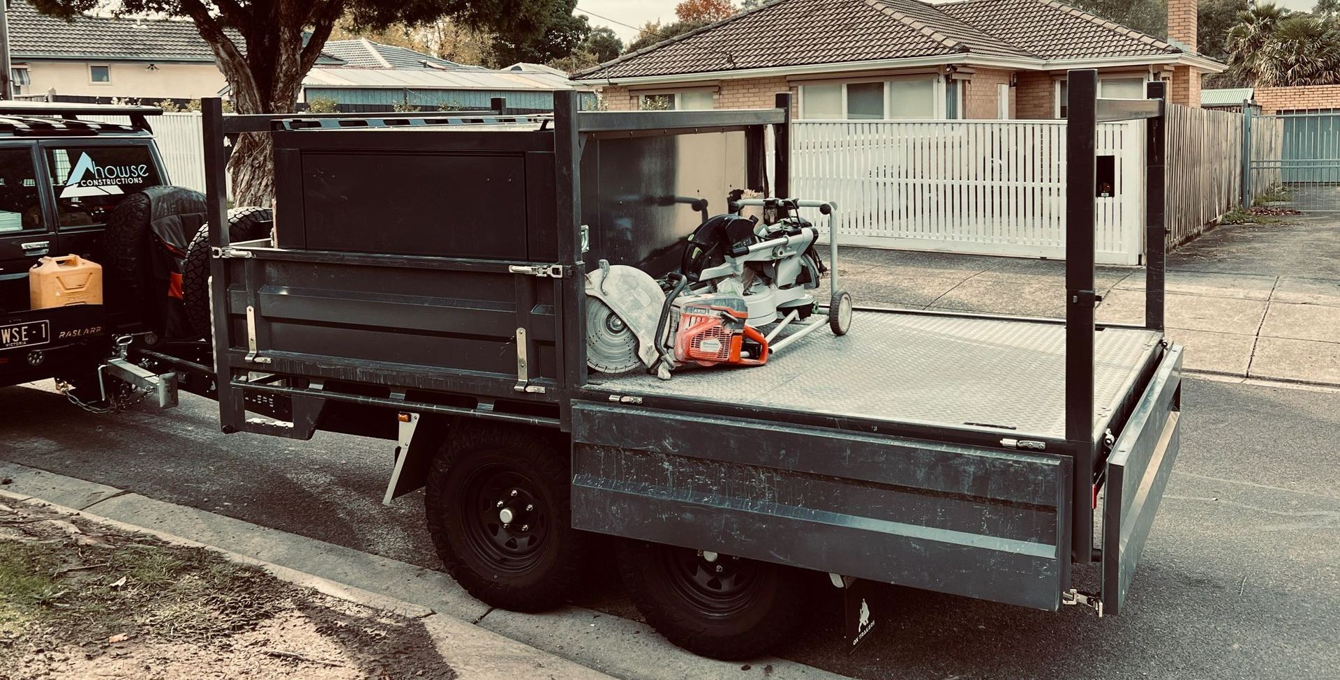 A Tipper Trailer with a lift of canopy at an active construction site with custom dropsides to suit canopy.