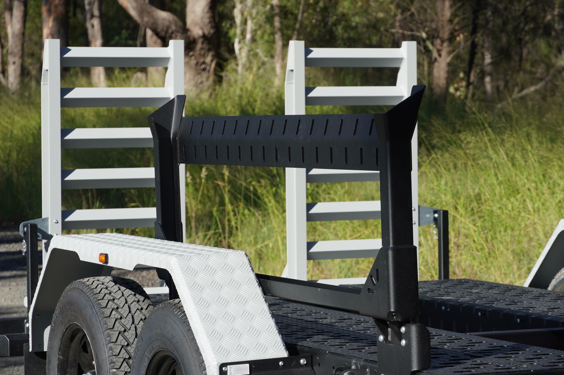 the skid steer spreader bar holder of an ox plant trailer.