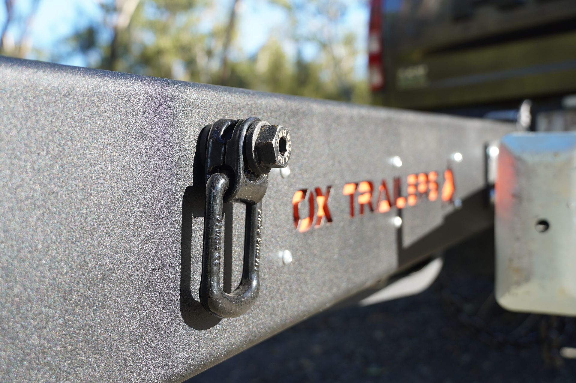 the bolt-on tie down point on the chassis of an ox plant trailer.