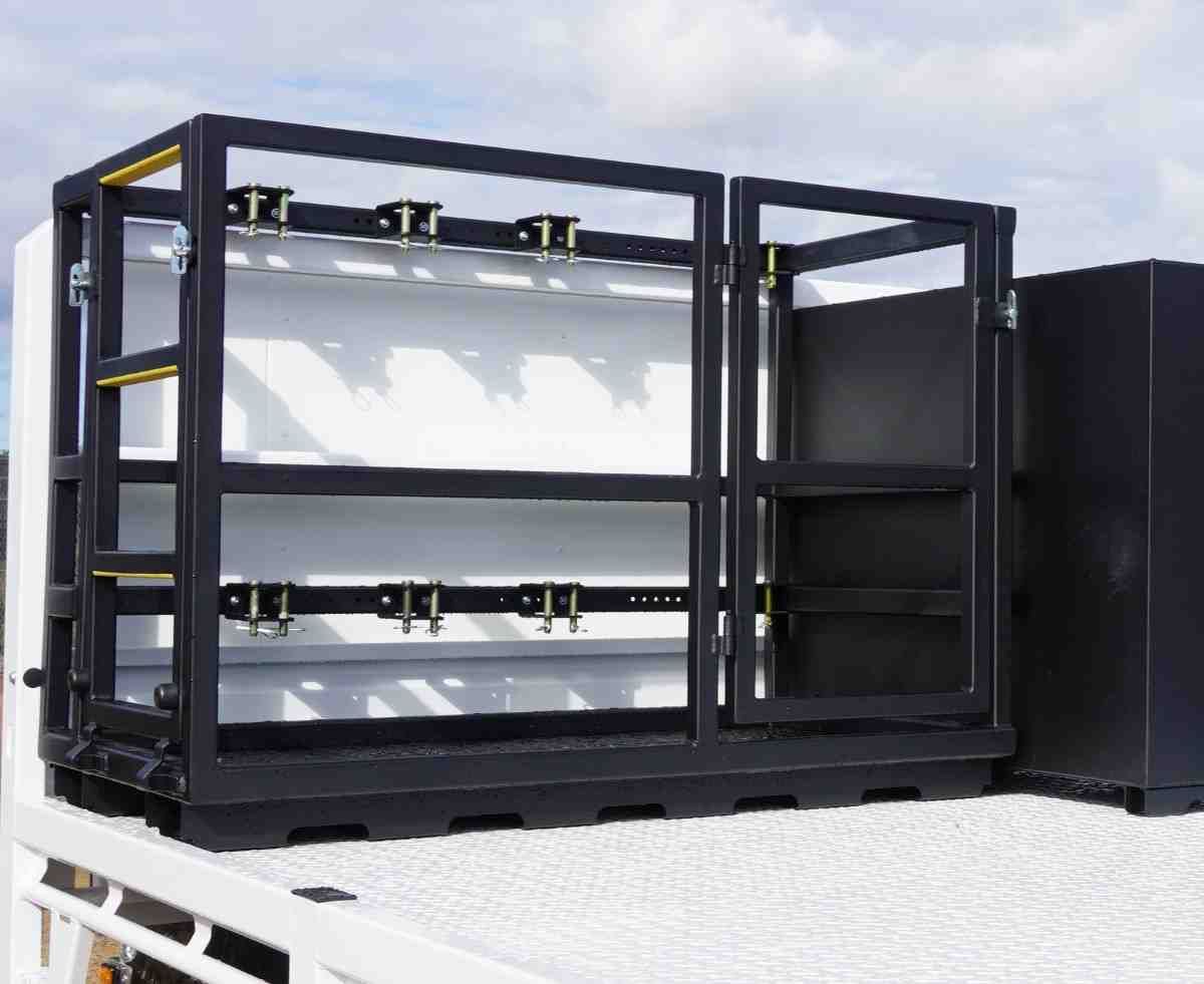 Gas cage with ladder and gate mounted on the tray of a custom mine spec trailer for mobile boilermaker.