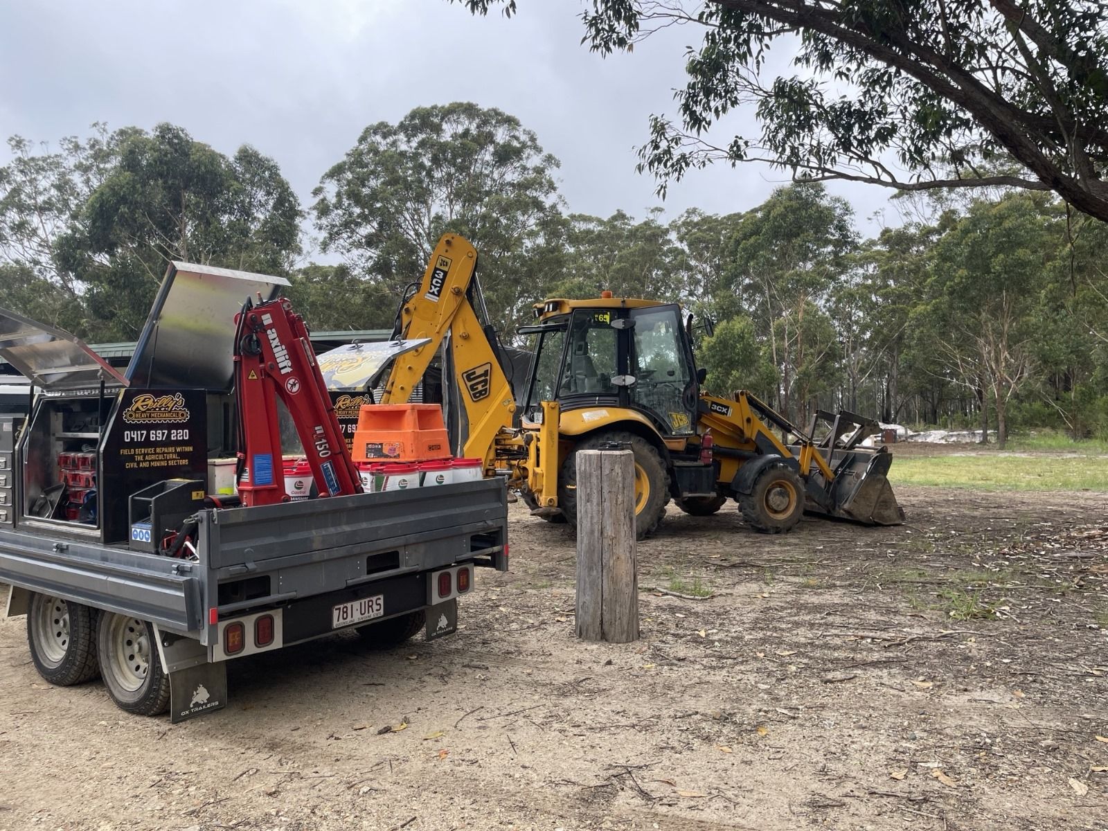 3.5t tough built flat top trailer for machinery repairs, performing maintenance on an excavator.