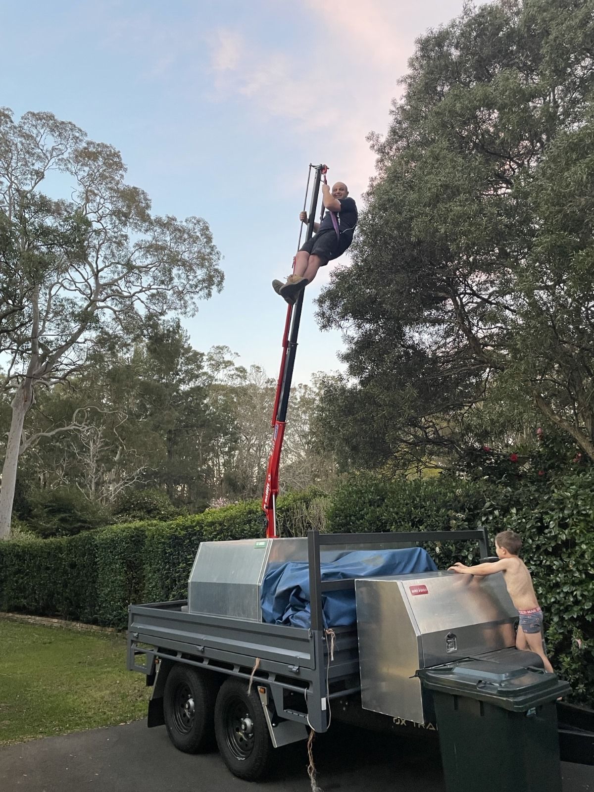 Dylan Reilly  a top his crane that is mounted onto his heavy duty diesel mechanic trailer.