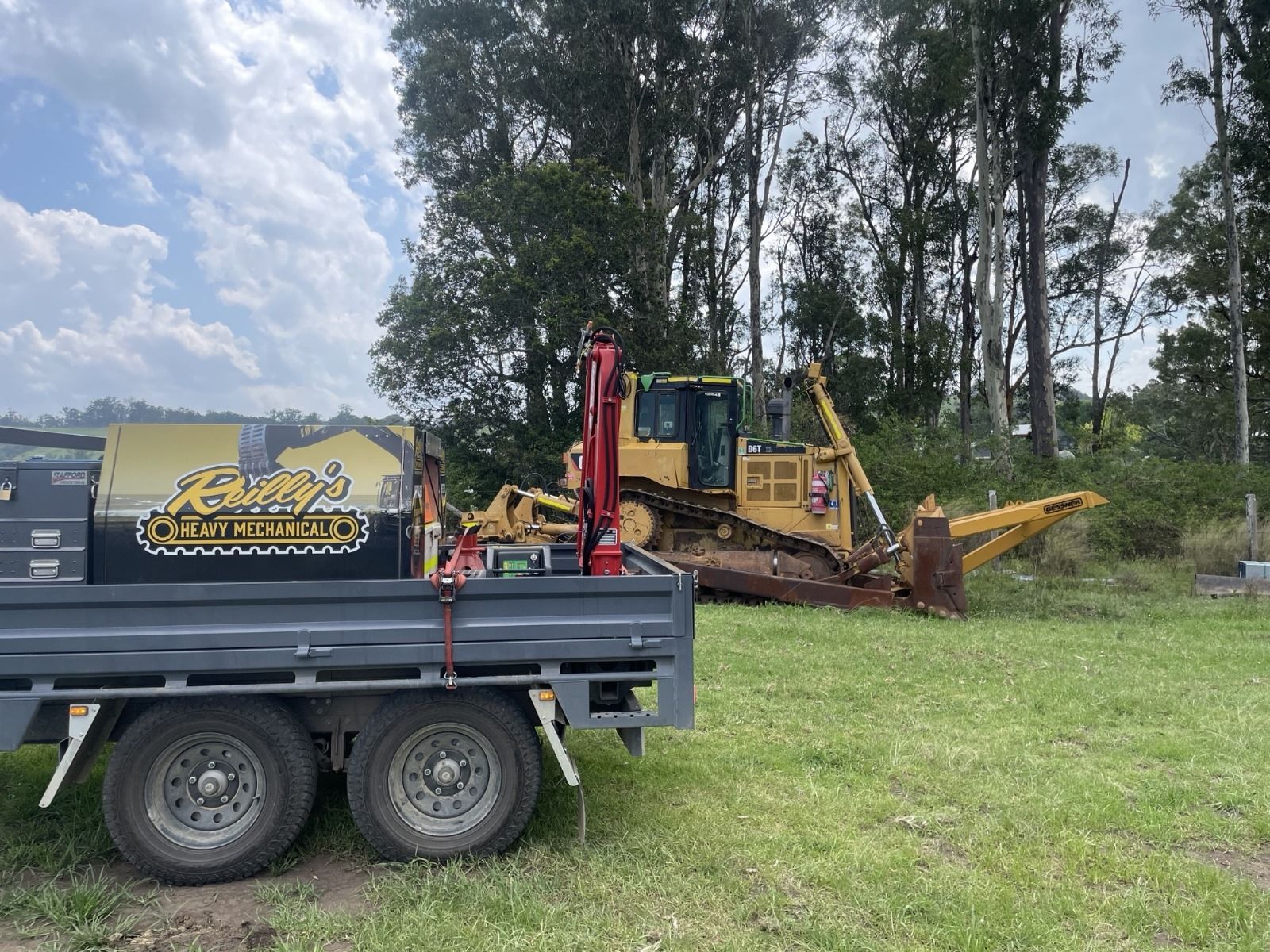 3.5t flat top trailer with tandem axles and a crane on site at quarry.