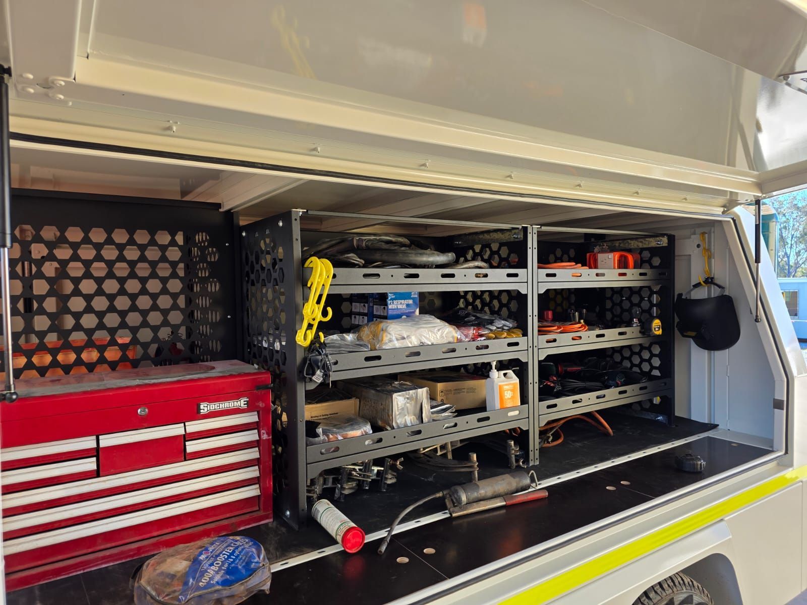 Heavy-duty, adjustable steel shelving in the custom service trailer for Wasco Energy by Ox Trailers