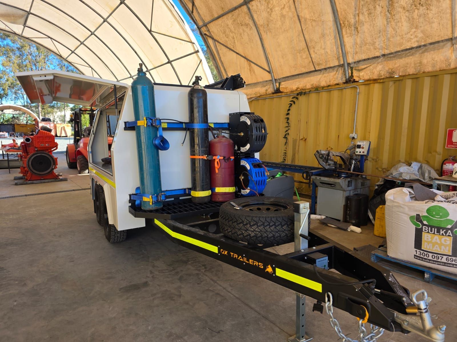 Heavy duty gas bottle storage on drawbar of custom ox trailers service trailer for wasco energy