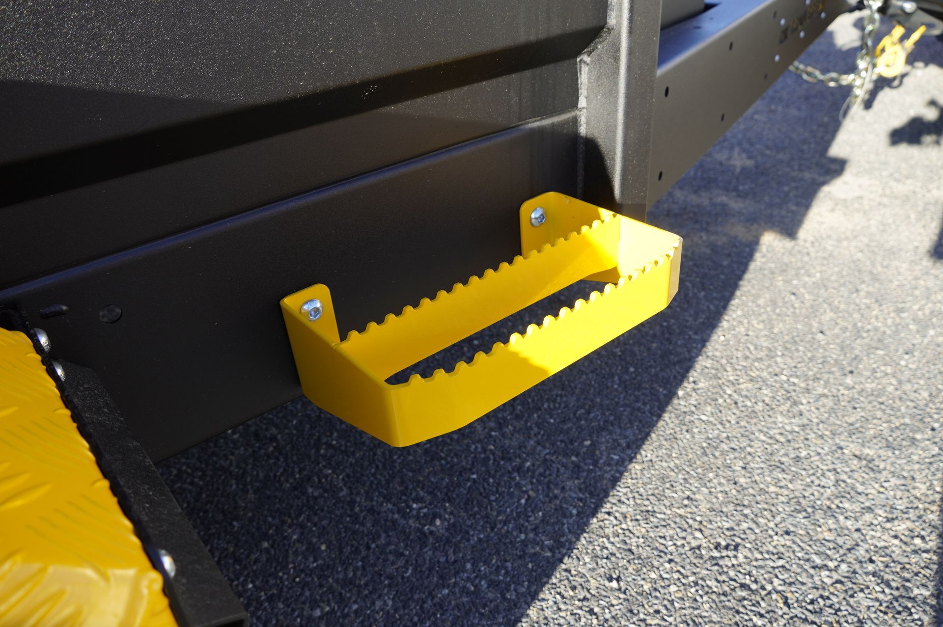 Bright yellow side steps attached to Ox Plant Trailer