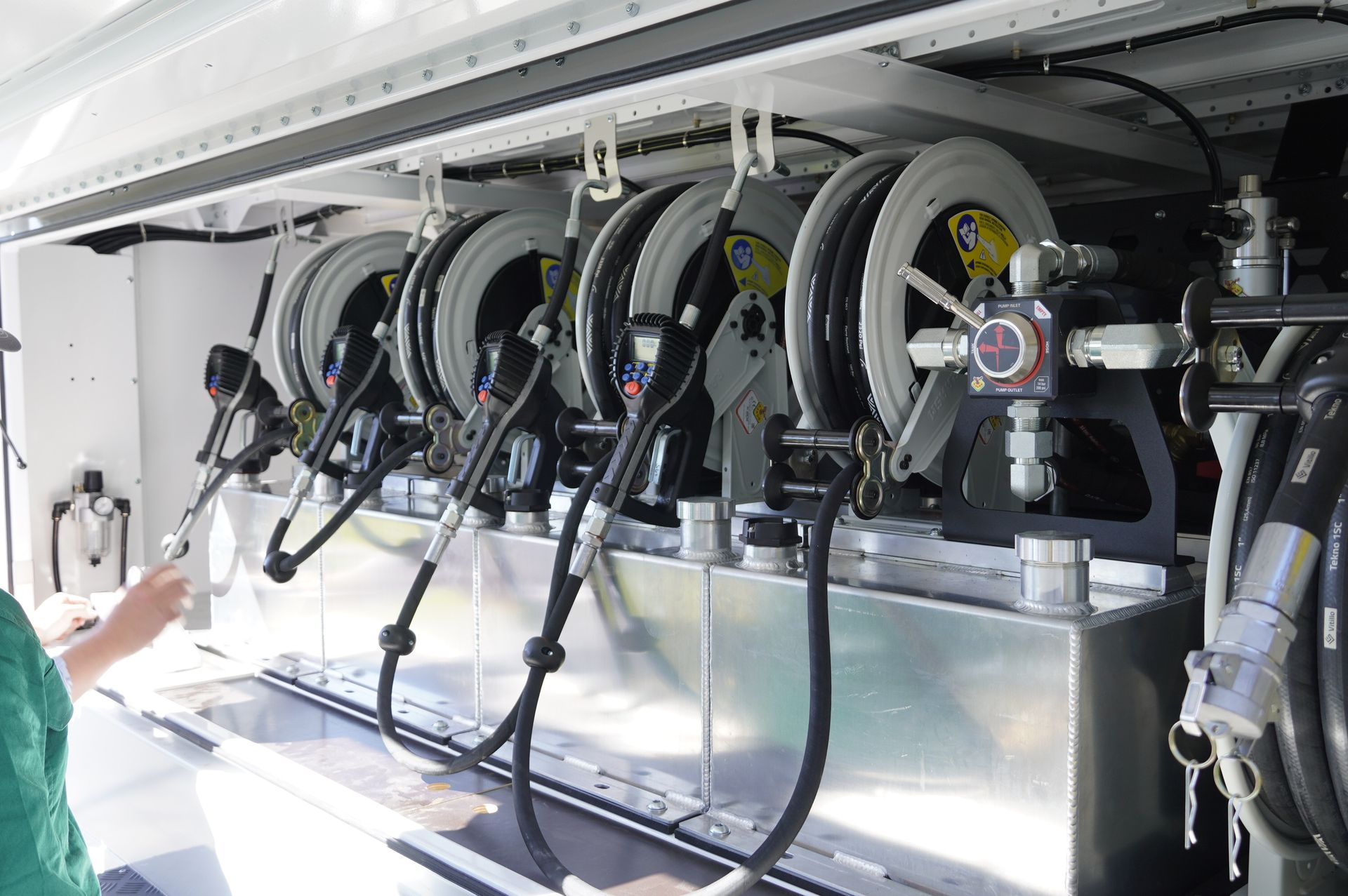 heavy duty custom flat top trailer for gee building at rural construction site with toolbox and canopy doors open.