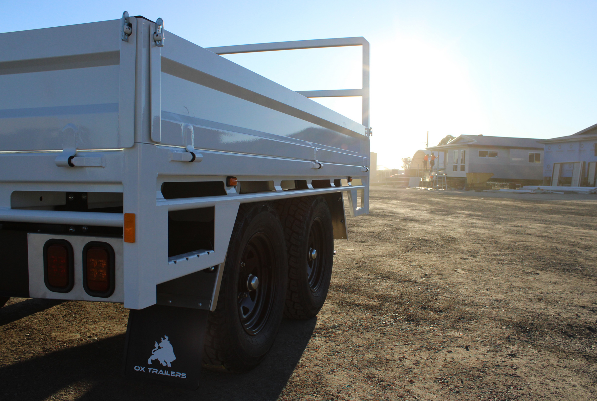 Image of an Ox Trailer with dropside extensions on a dirt road.