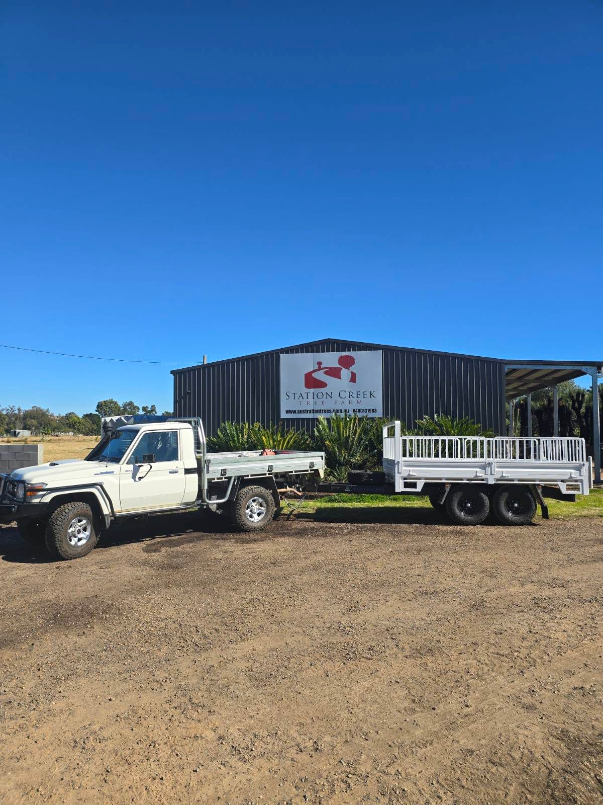 One of the Station Creek Flat top trailer at their farm, being towed behind a landcruiser.