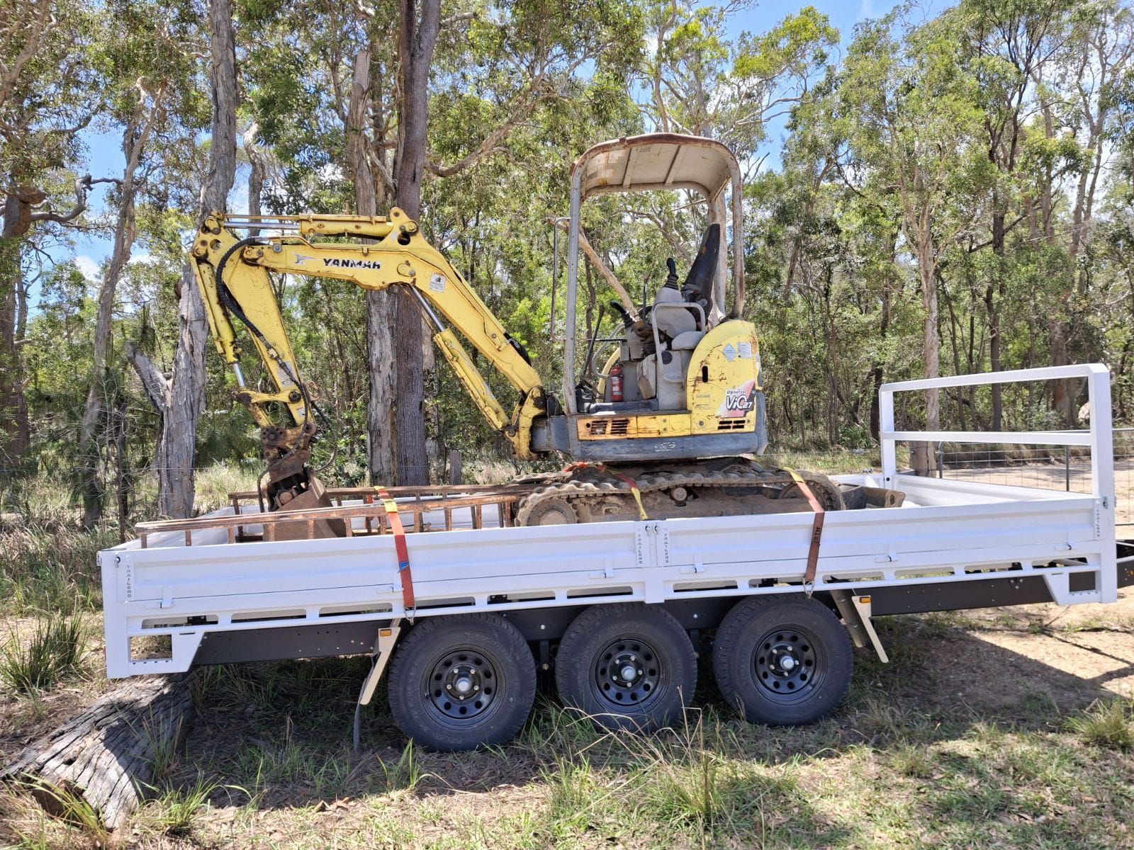 TC Malouf's tri-axle trailer carrying his excavator.