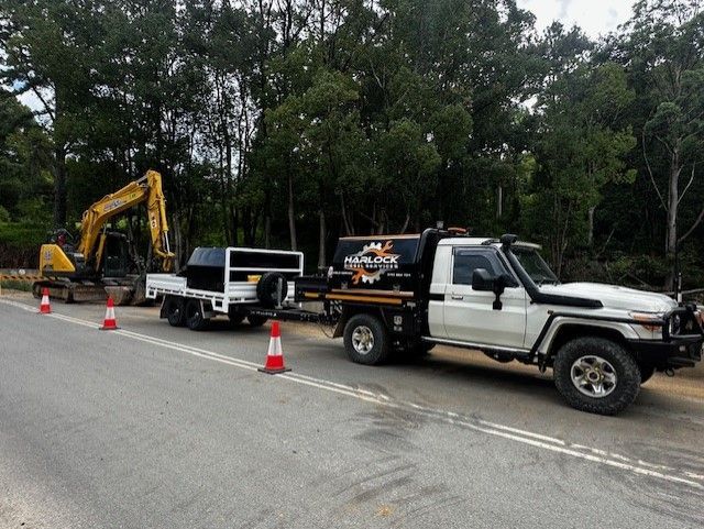 An Ox Trailers Flat Top Trailer on a council site, fixing large machinery.