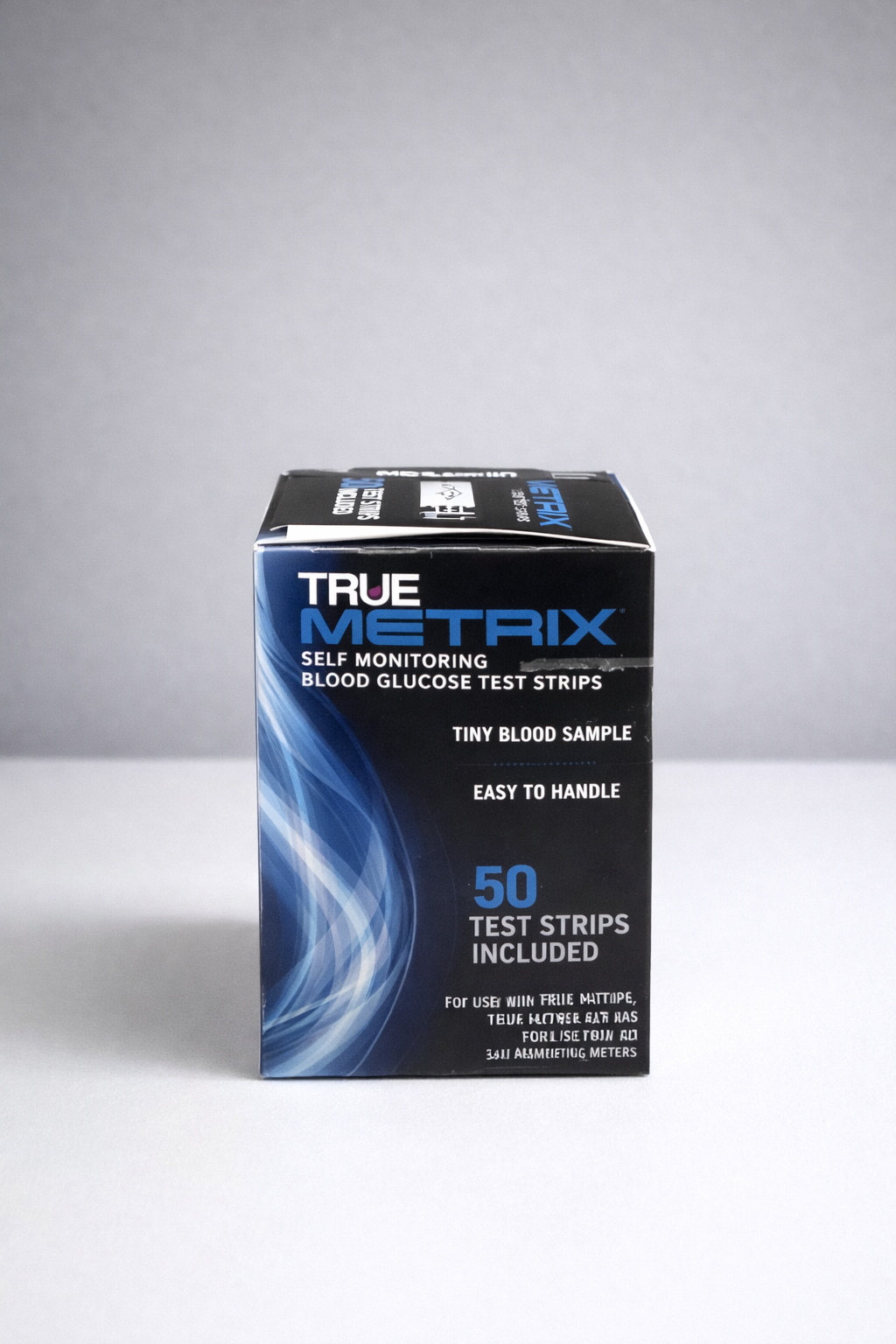 Box of True Metrix blood glucose test strips on a white surface. The box is blue and black with white text.