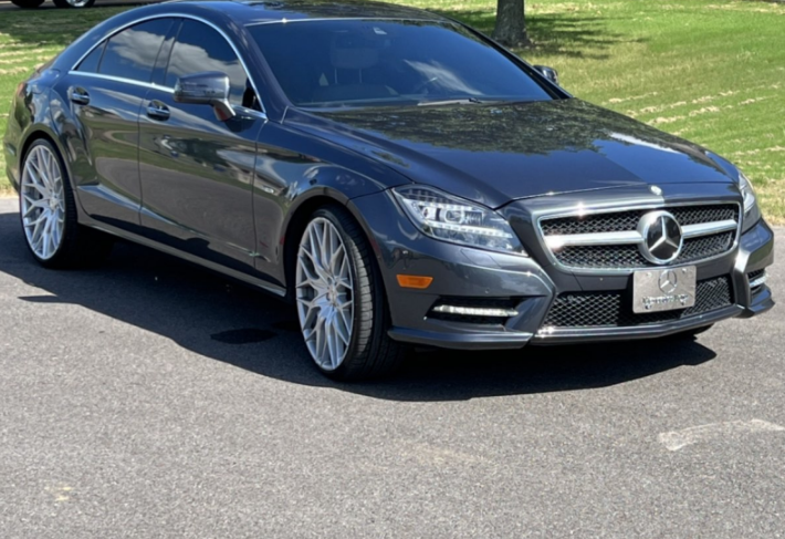 Gray Mercedes-Benz coupe parked on a sunny street, front three-quarter view
