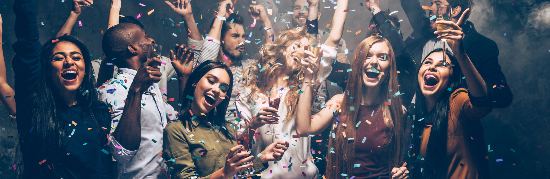 Friends cheering and throwing confetti at a lively party, smiling under colorful lights