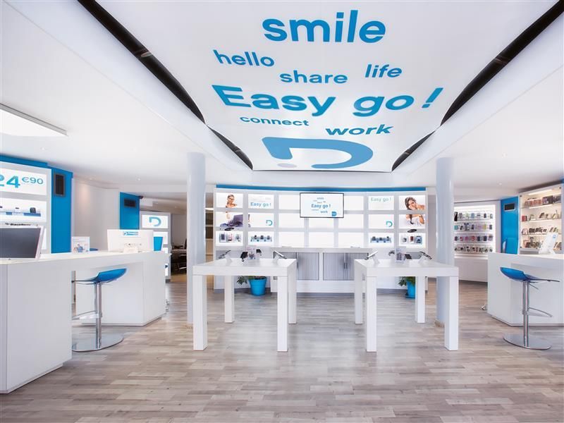 A store with a ceiling that says smile hello share life easy go connect work
