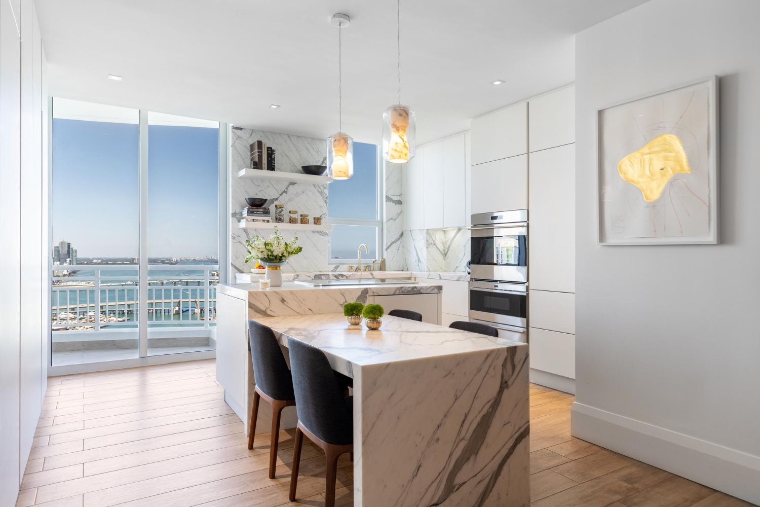 A kitchen with a large island and a table and chairs.