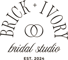 Logo for Brick + Ivory bridal studio, with arched text above two linked rings, and 