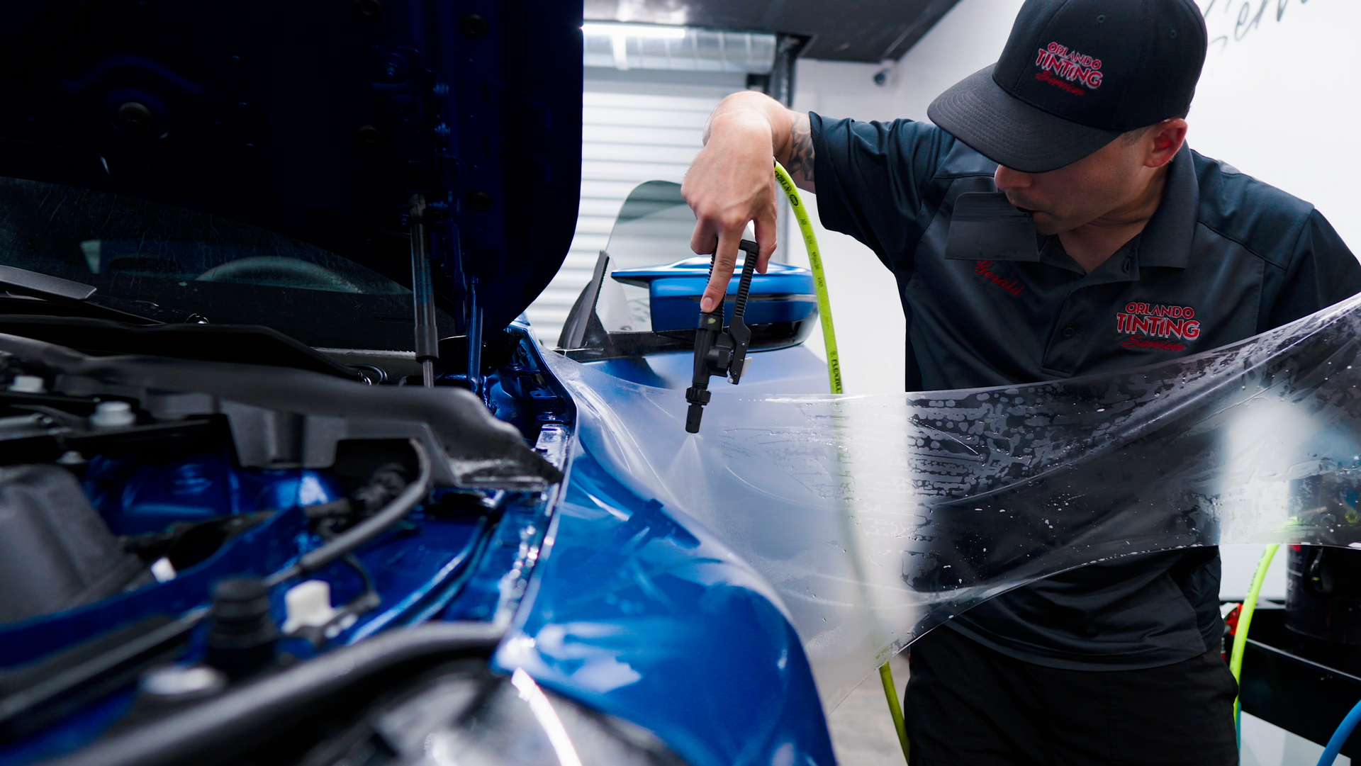 A close up of water drops on the hood of a car