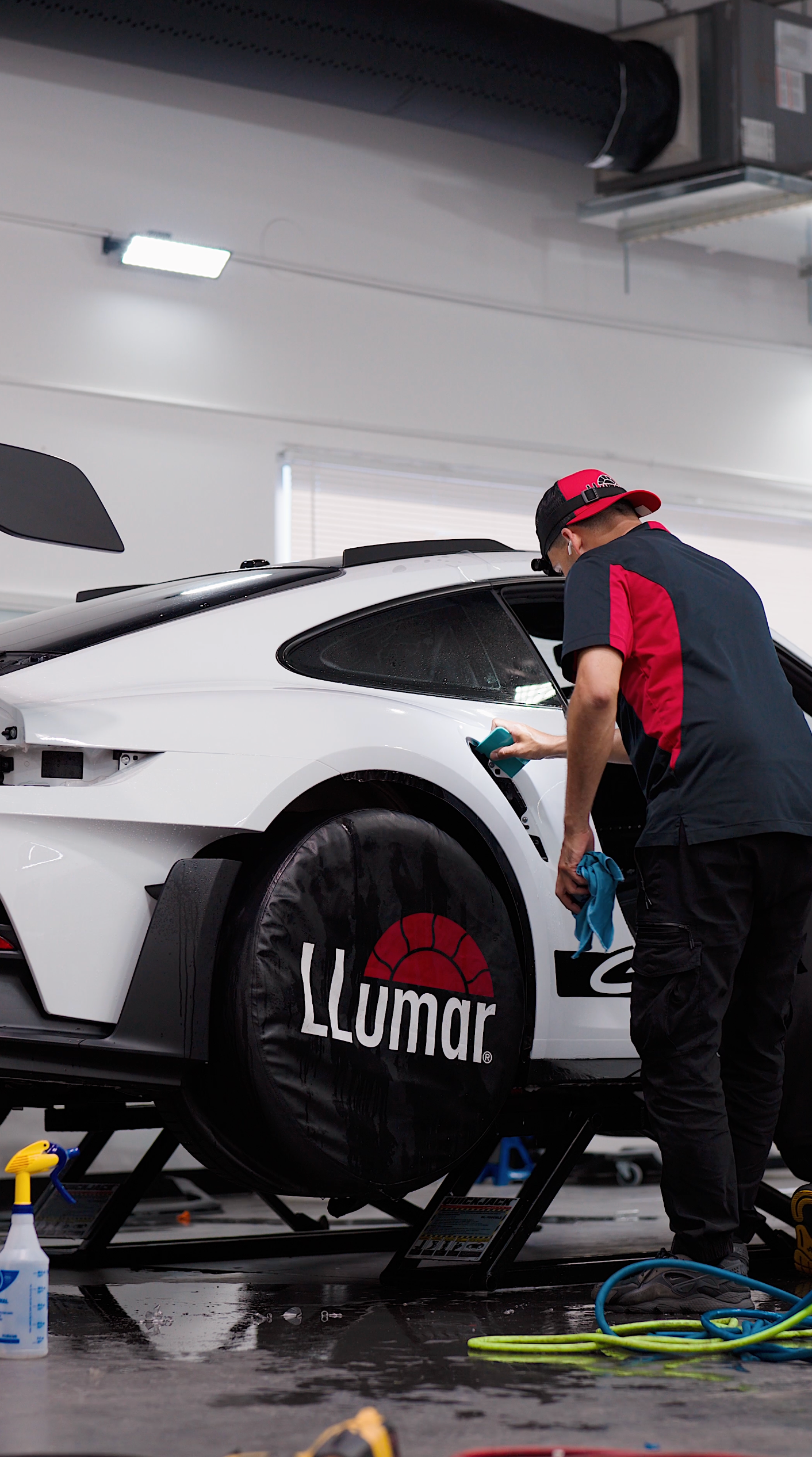 A yellow sports car is parked in a garage.