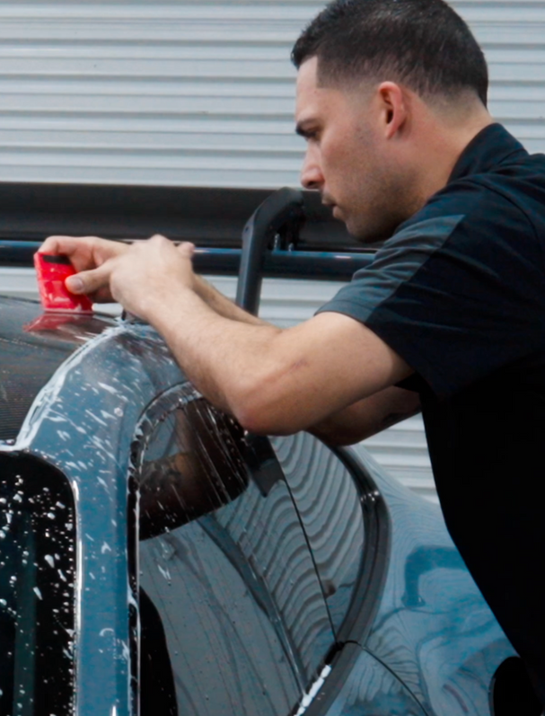 A close up of water drops on the hood of a car