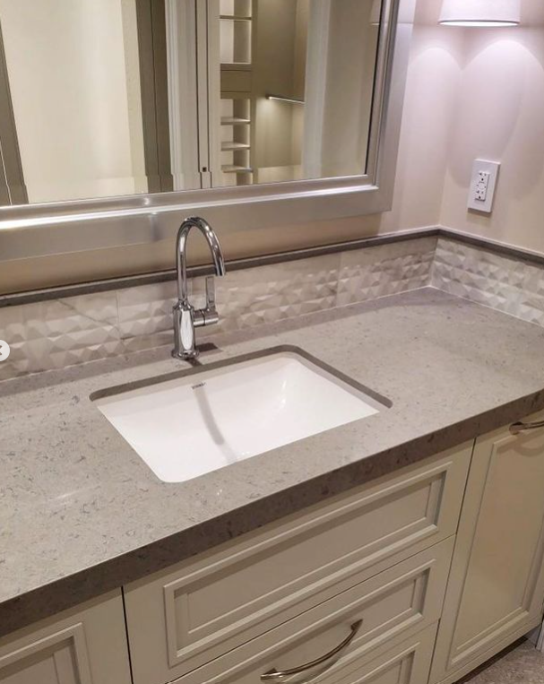 A bathroom sink with a faucet and a mirror