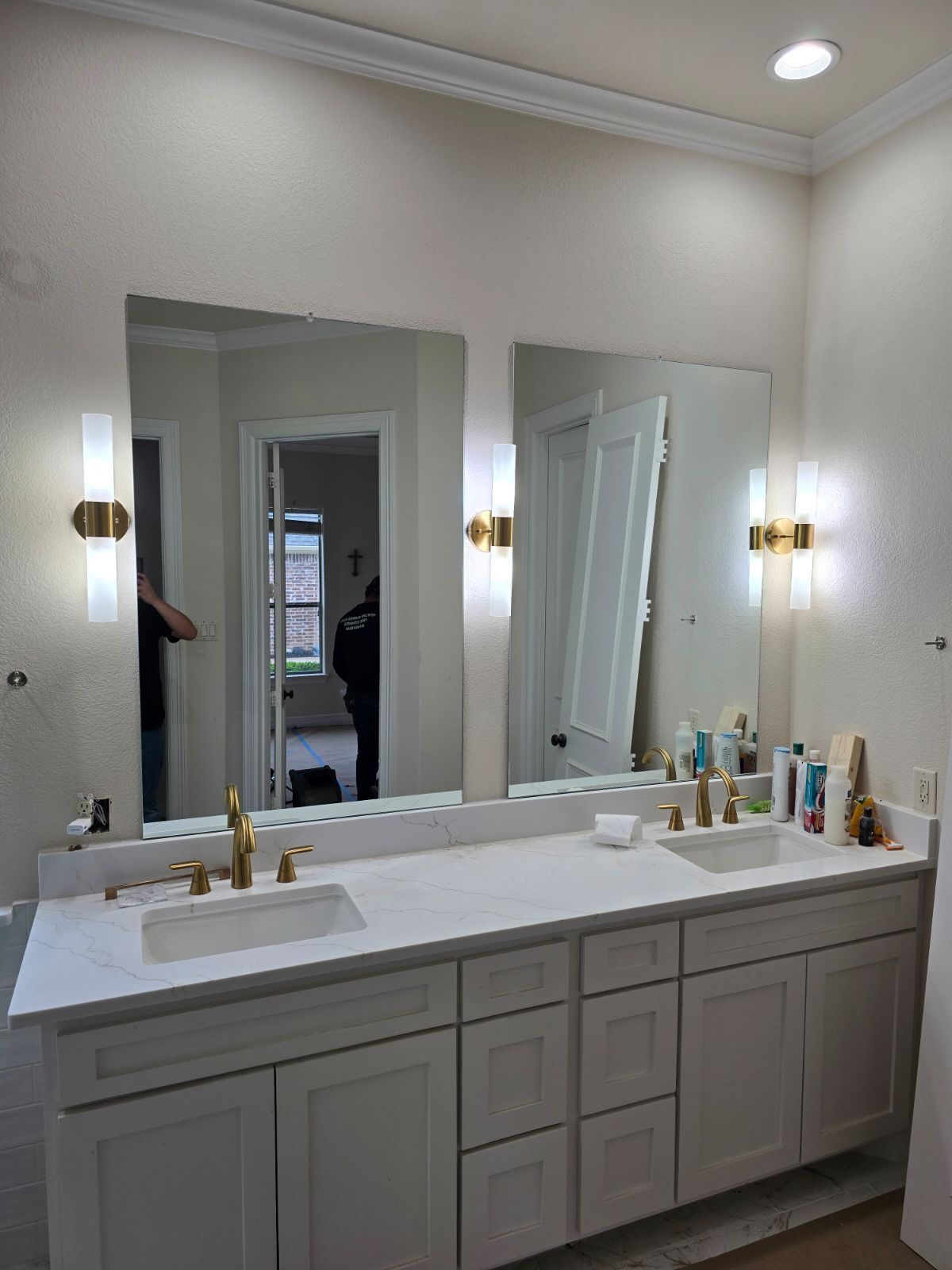 A bathroom with two sinks and a large mirror.