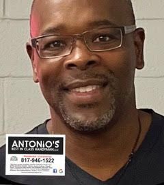 A man with glasses and a beard is smiling for the camera.