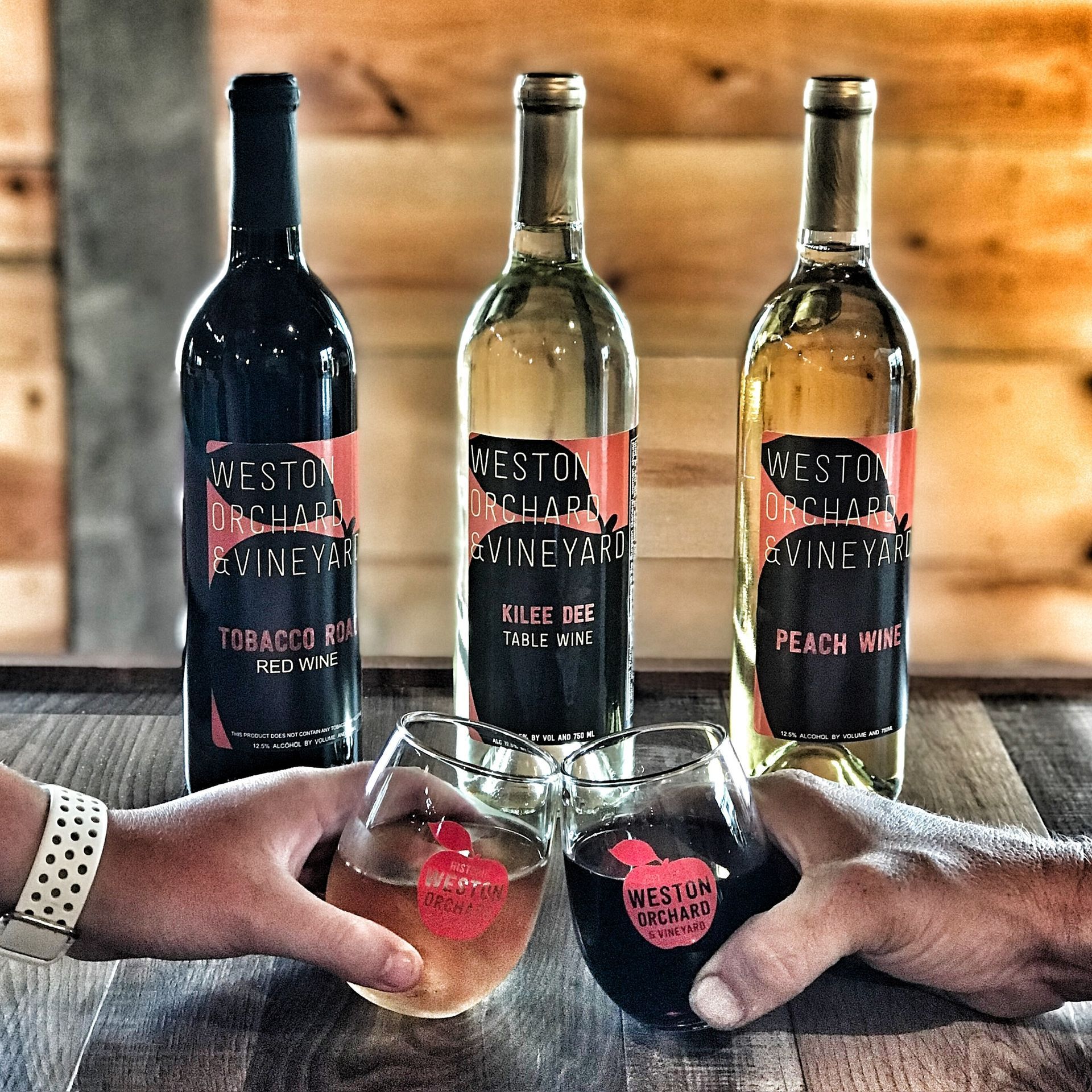 Three bottles of weston vineyard wine are on a table