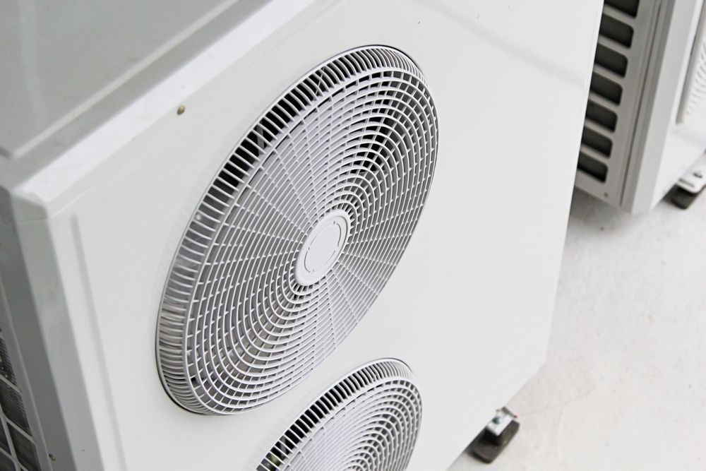 White air conditioning units with fan grilles in Nowra