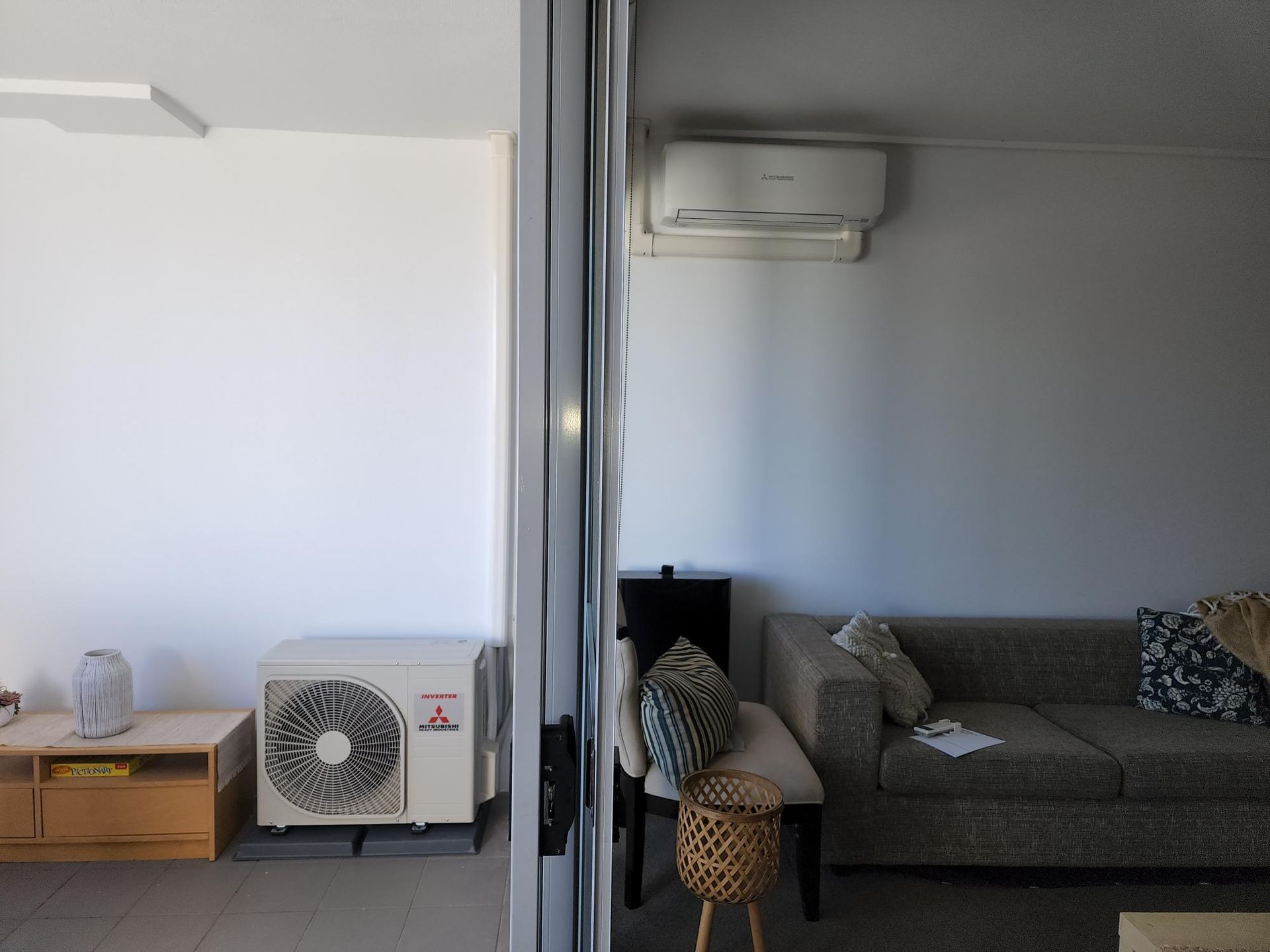 Interior view with an air conditioner, sofa, and balcony in Nowra