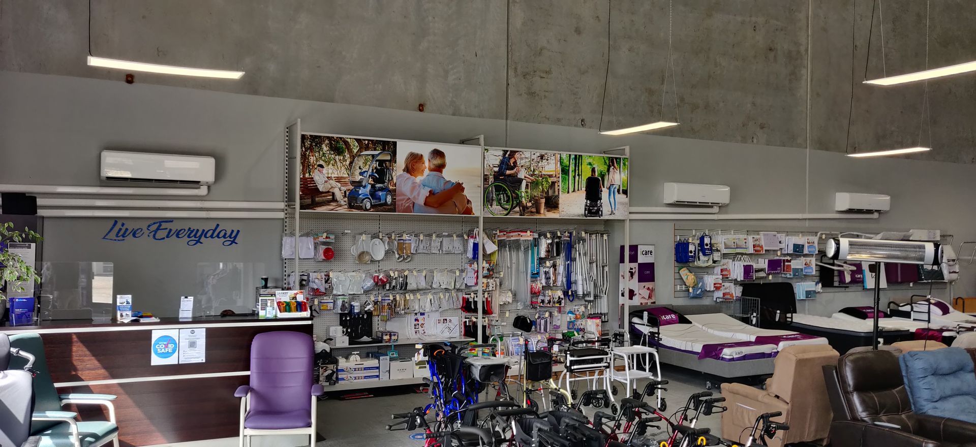 Interior shop with Denali Air Conditioning equipment and supplies, posters above display shelves, and a reception area.