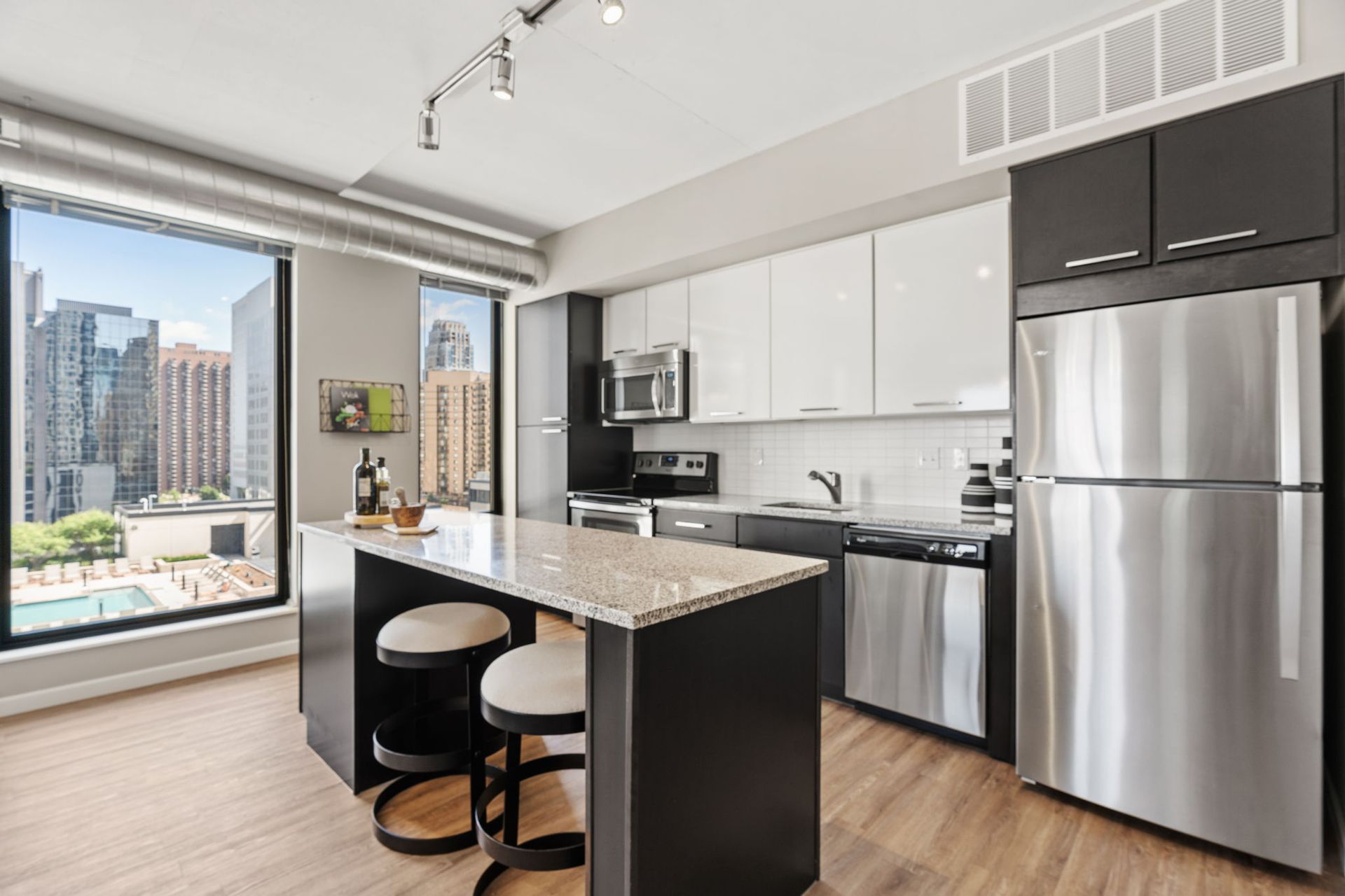 A kitchen with stainless steel appliances and granite counter tops