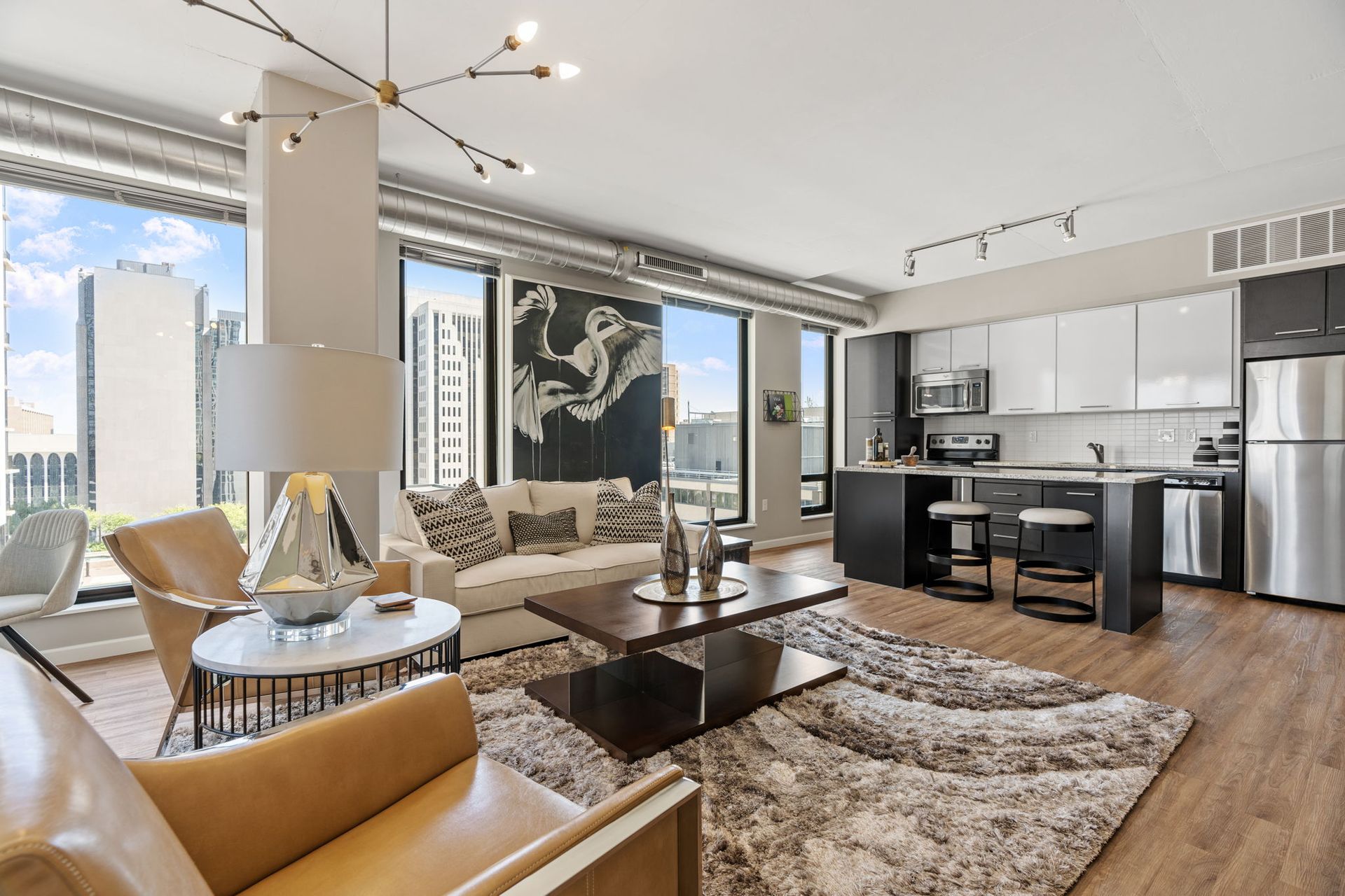 A living room with a couch , chairs and a coffee table