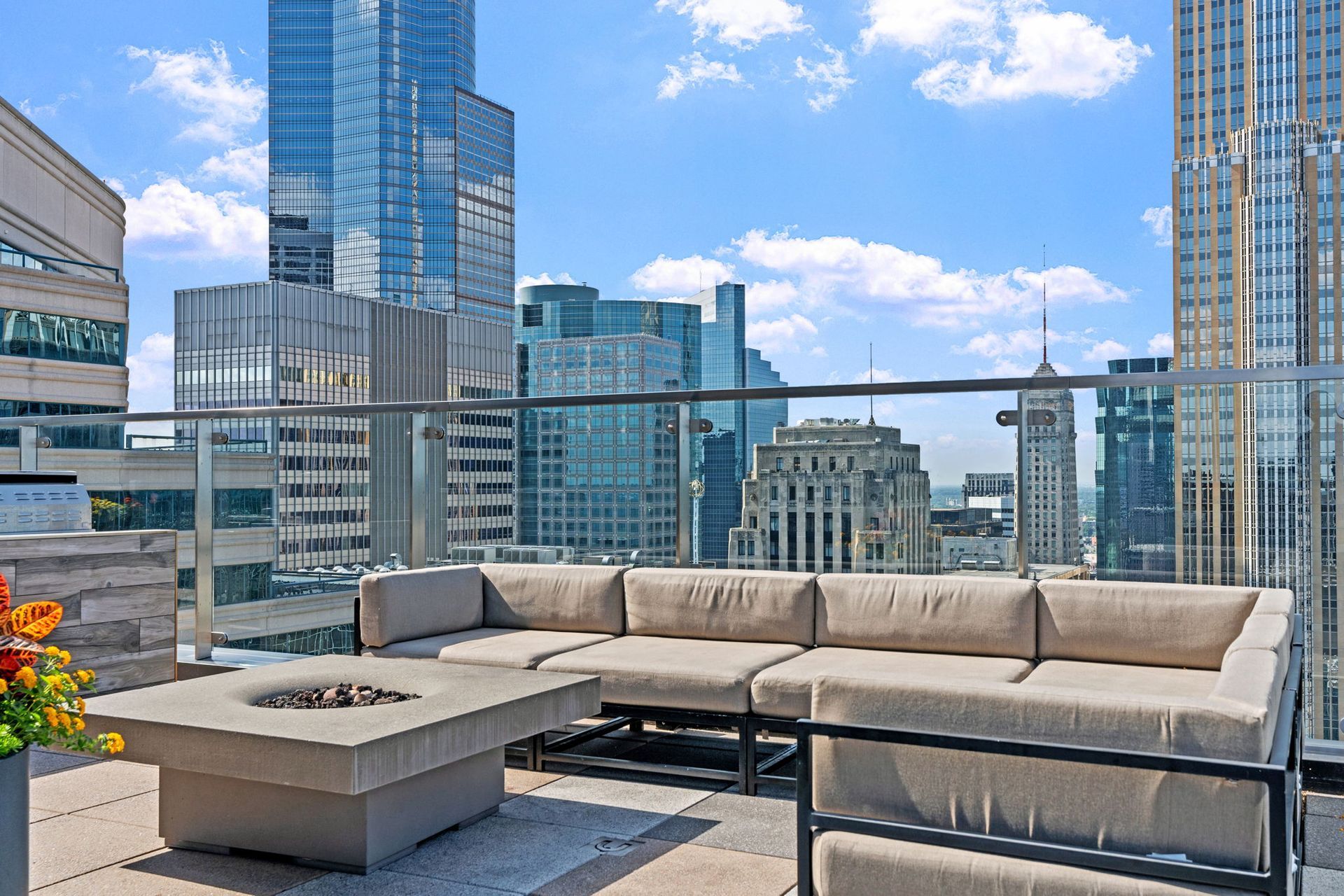 There is a fire pit on the patio with a view of the city.