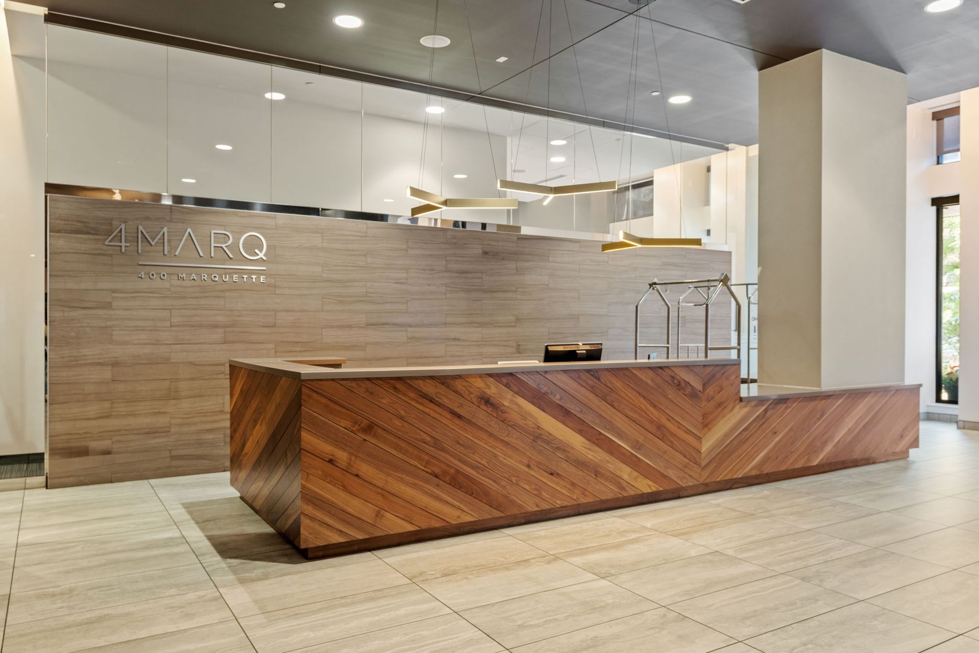 Modern hotel lobby with wooden reception desk and 
