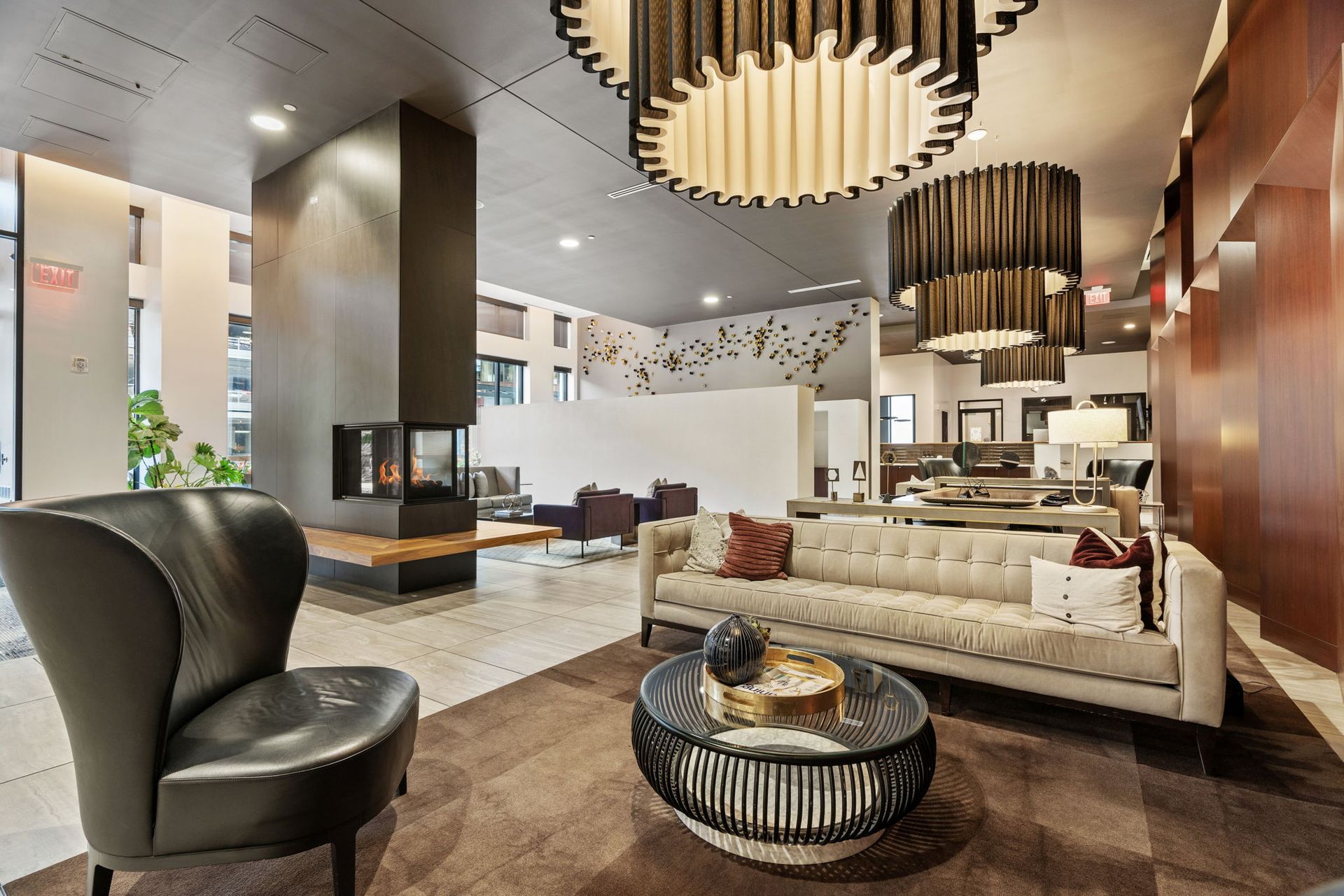 Stylish lobby with fireplace, seating area, and circular light fixtures.