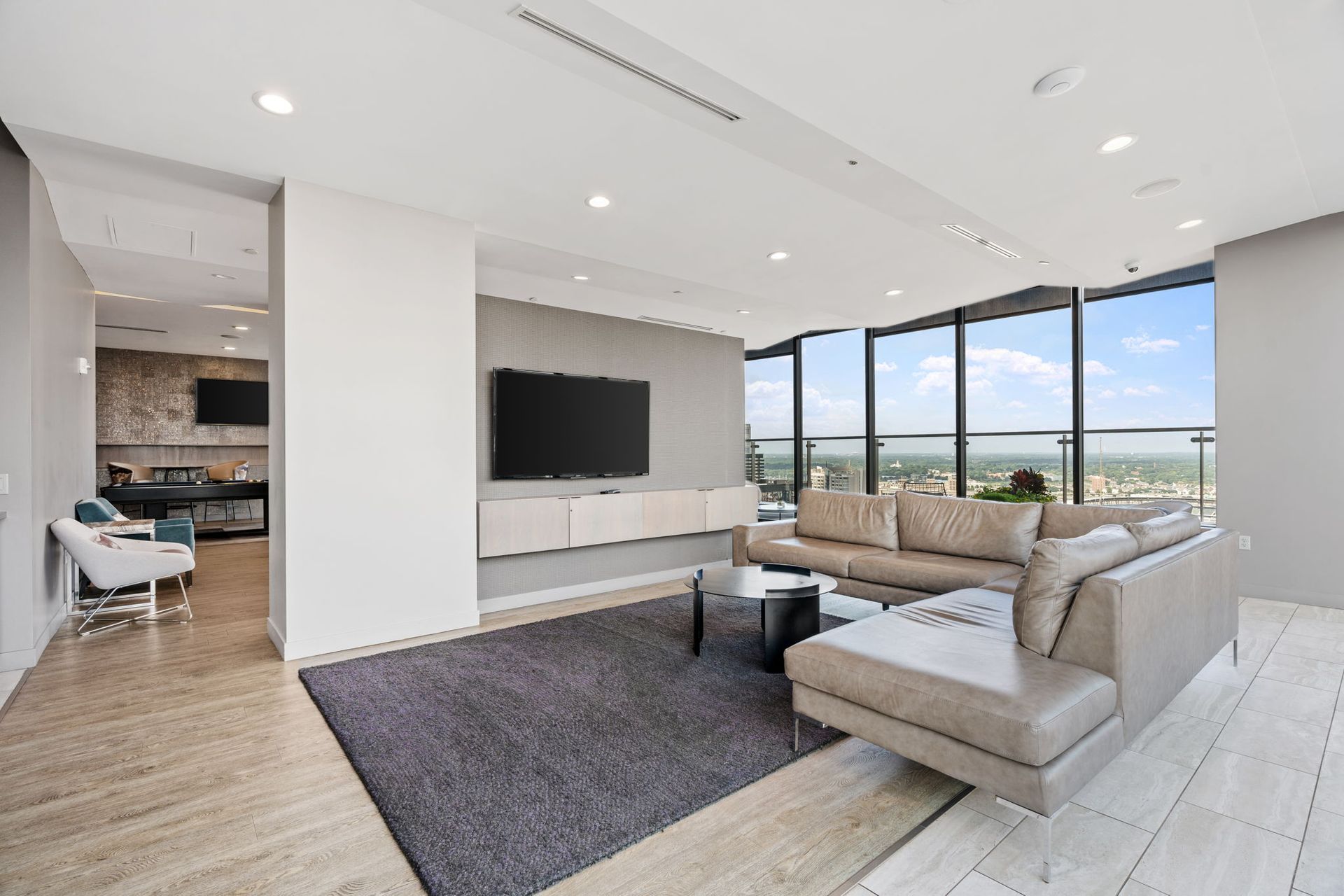 A living room with a couch , chair , table and television.