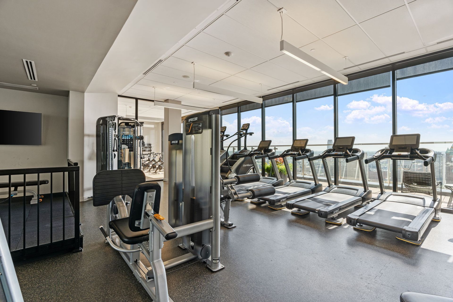 A gym with a lot of treadmills and exercise equipment.
