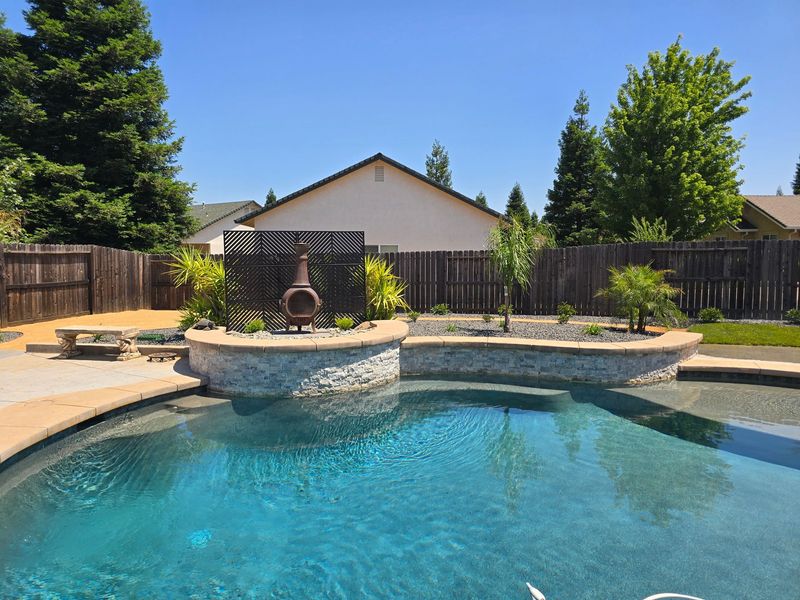 A large swimming pool in the backyard of a house