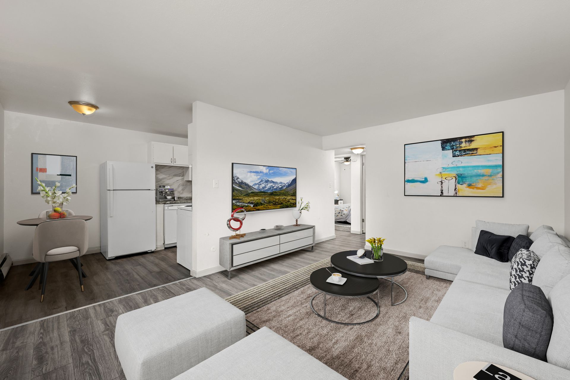 Photo showing a living room with a separated kitchen