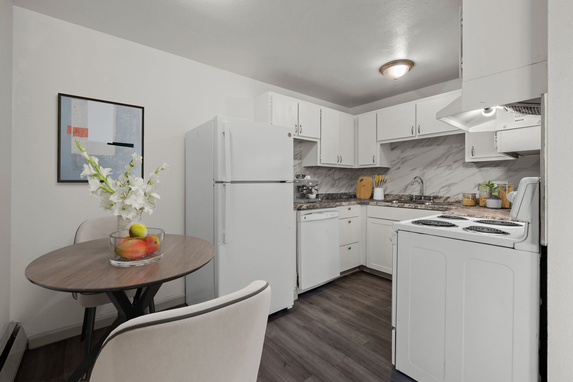 Photo showing a kitchen with a small dining area