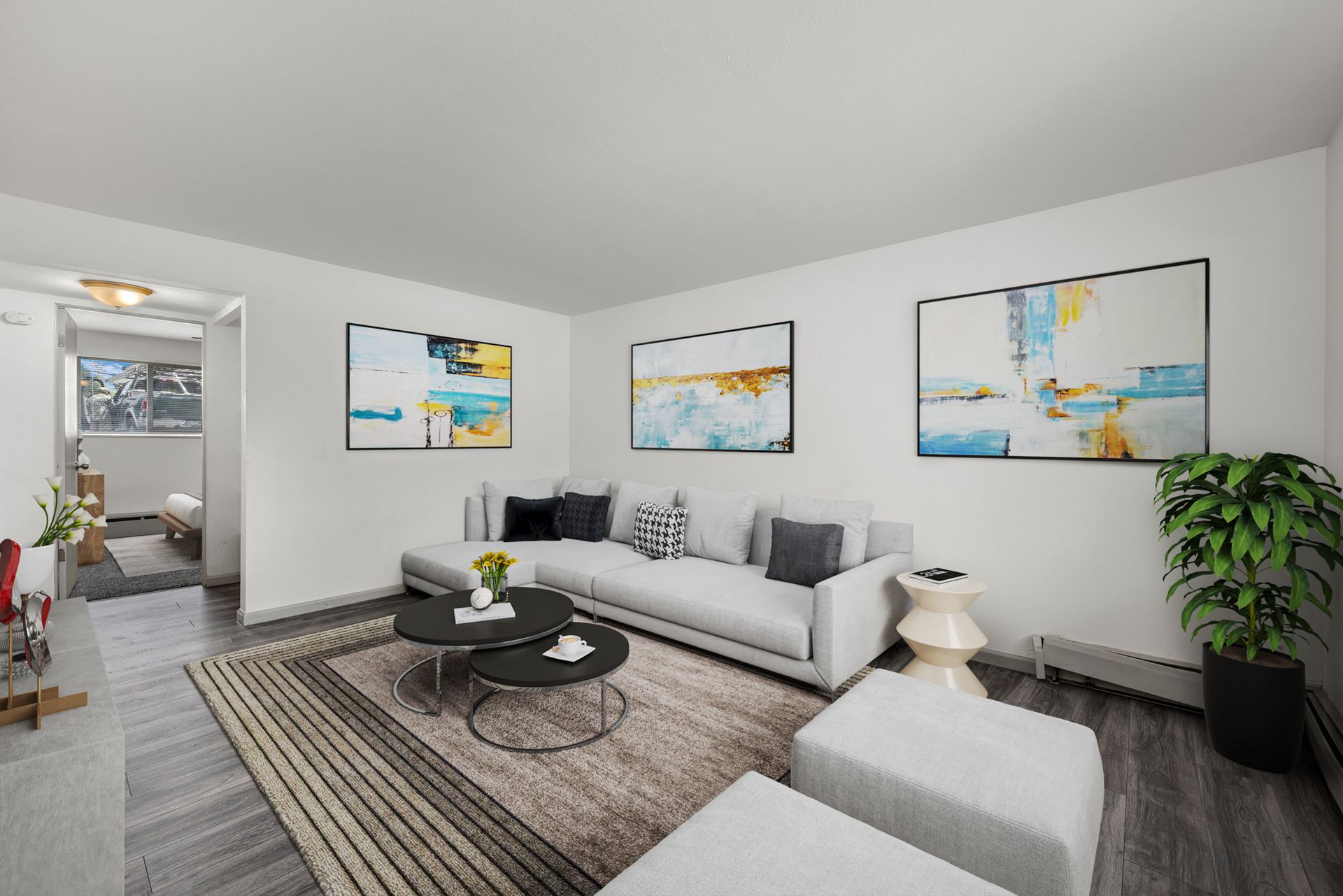 Photo showing a living room with a bedroom in the background