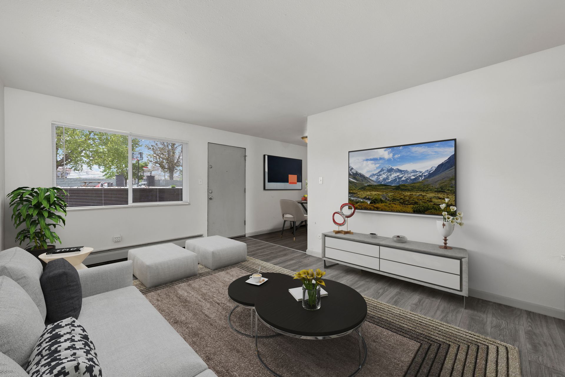 Photo showing a living room with the dining area in the background