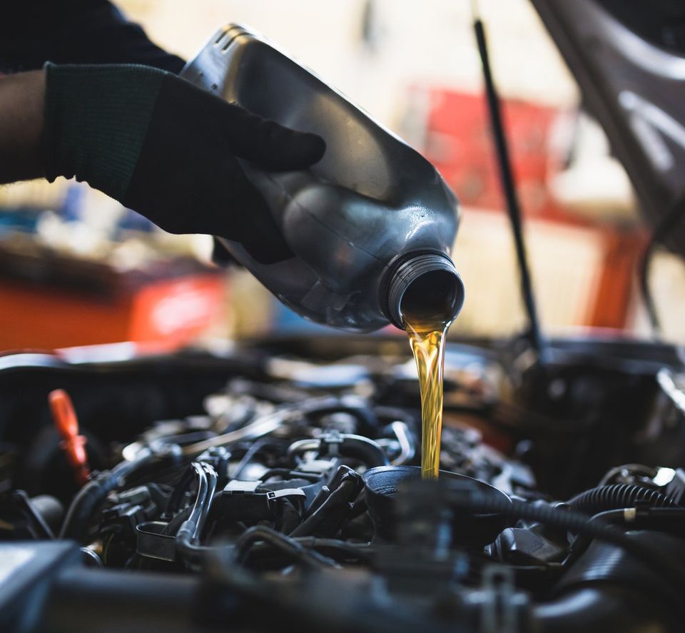 Pouring Oil To Car Engine — Golden Valley, MN — Boulevard Automotive & Towing
