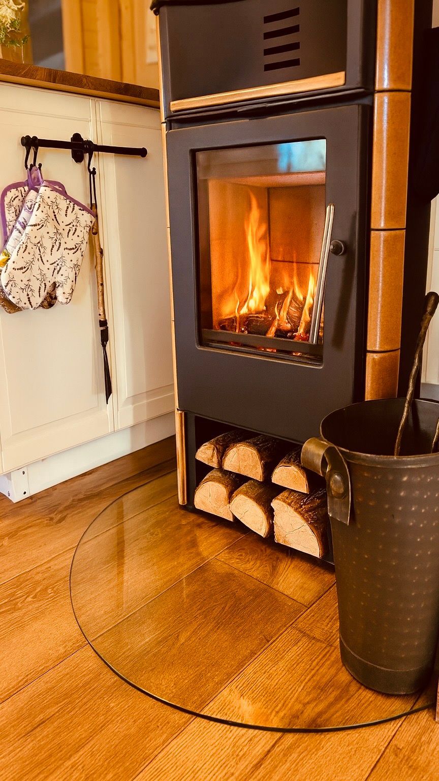 Night garden illuminated by spotlights; bushes and trees in the dark.