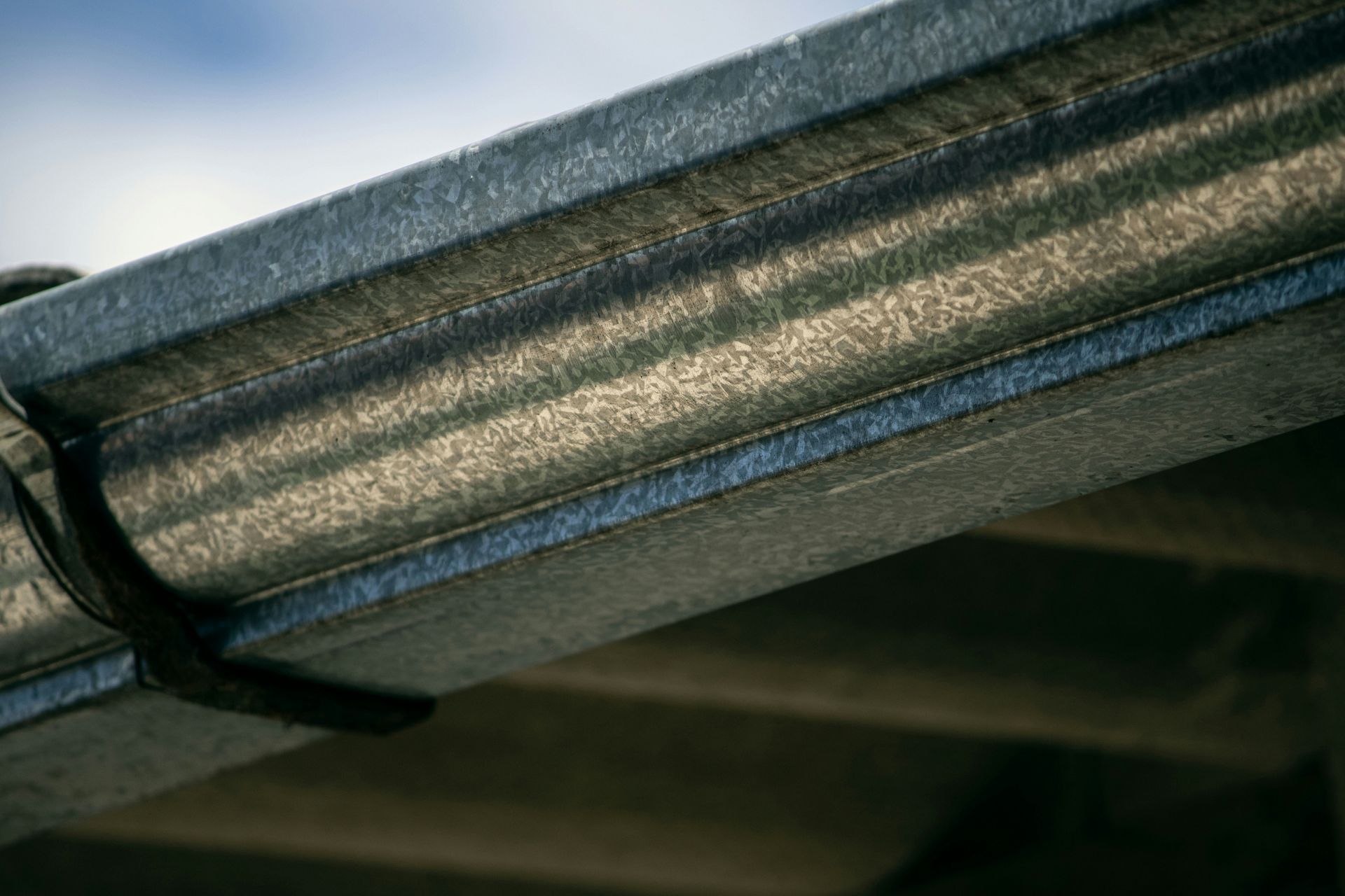 A close up of a metal gutter on a roof.