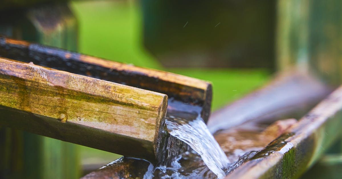 A close up of a water fountain made of wood.