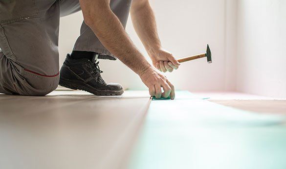 Man Installing Hardwood Floors — Hazelwood, MO — Floors Done Right